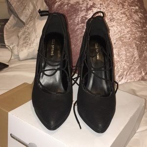 Black closed toed strap-up heals.